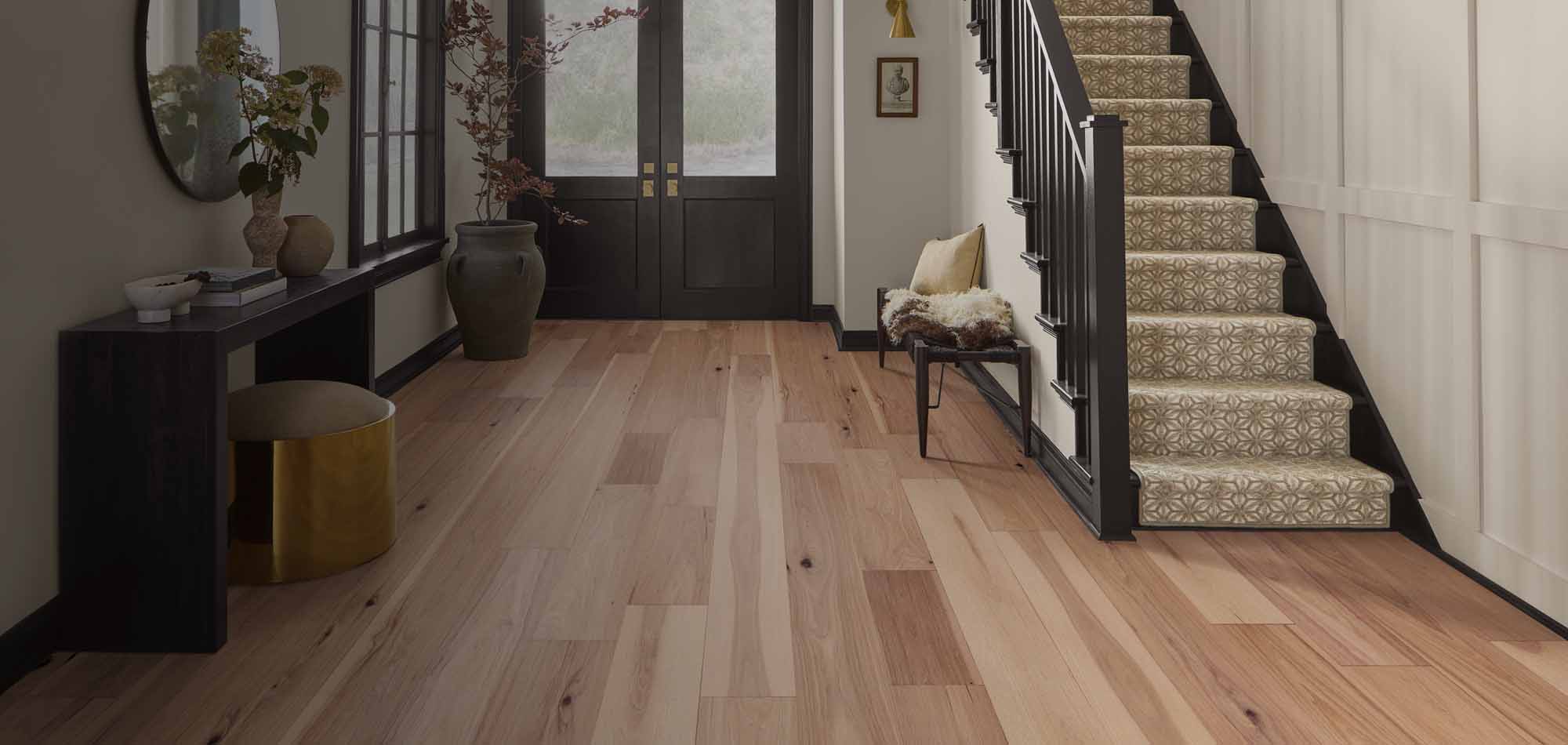 flooring in entry way wood look and carpet on stairs